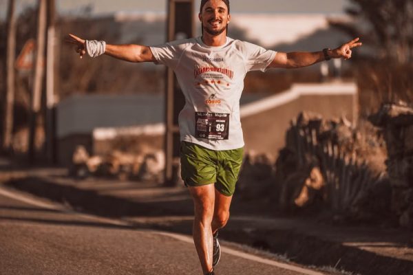 Smiling runner enjoys the thrill of a marathon on a sunny day outdoors.